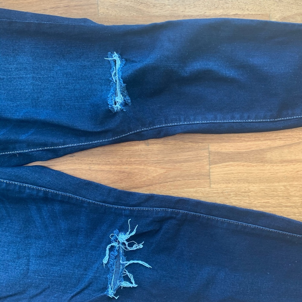 Distressed dark denim jeans